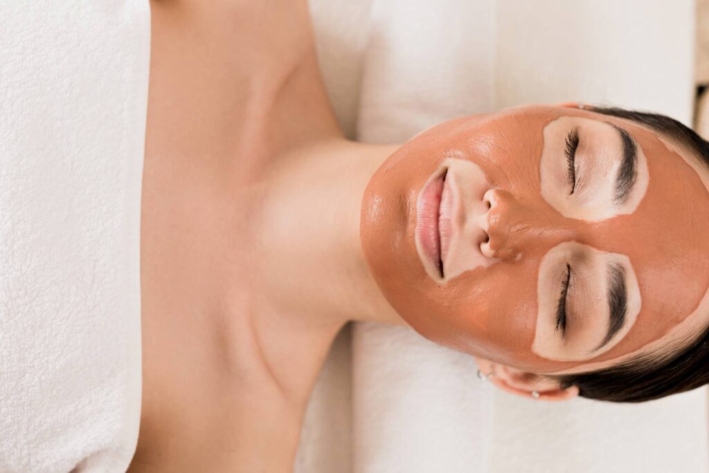 woman laying down and getting a facial